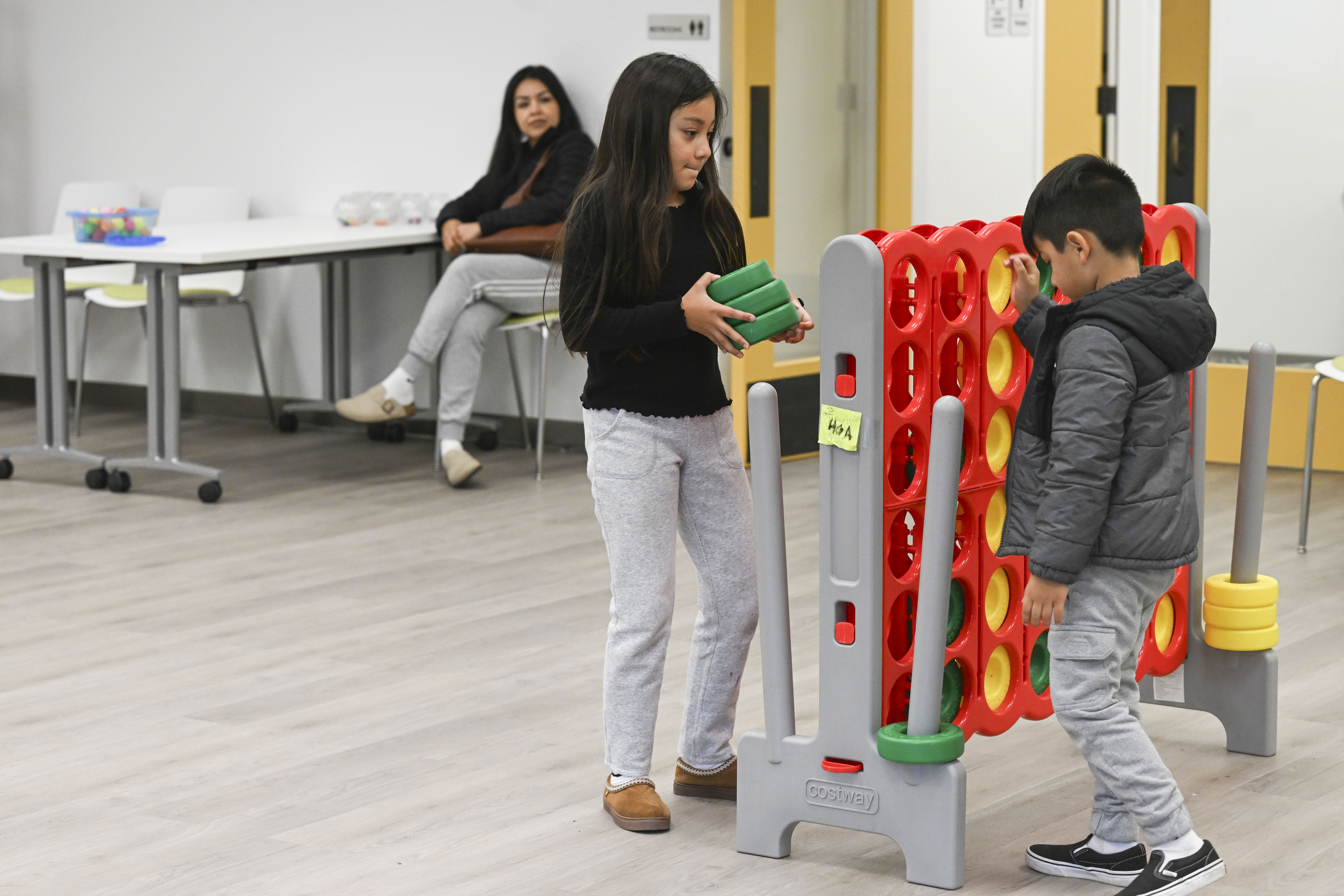 Griselda Velazquez, rear, watches children Ariana Velazquez and Aldo Velazquez...