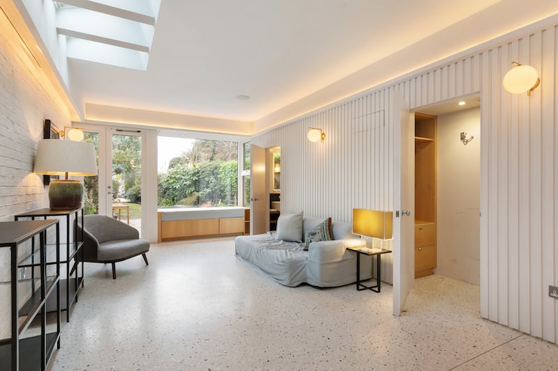 Hidden storage and a loo lie behind a panelled wall in the extension