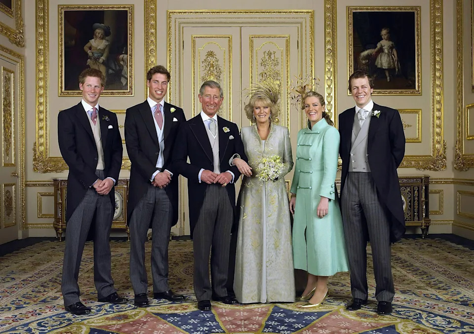 King Charles and Queen Camilla posing for a formal portrait with their children on their wedding day