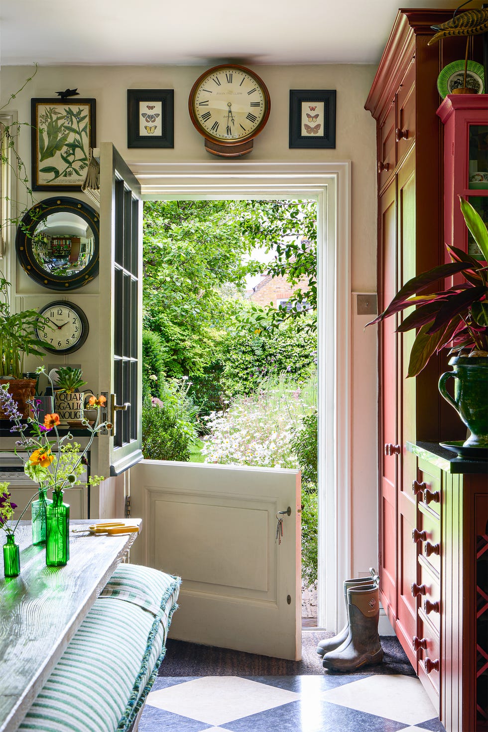 Open door leading to a garden with decorative elements inside the home.