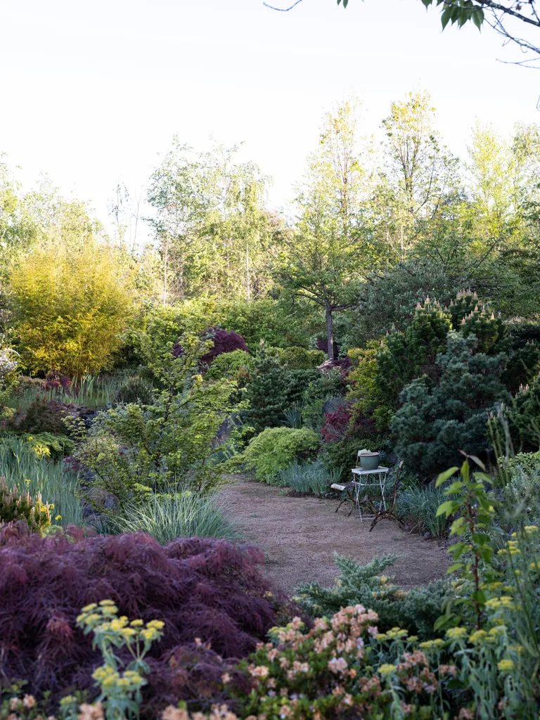 A gravel clearing with a table and chairs in Highfield Garden