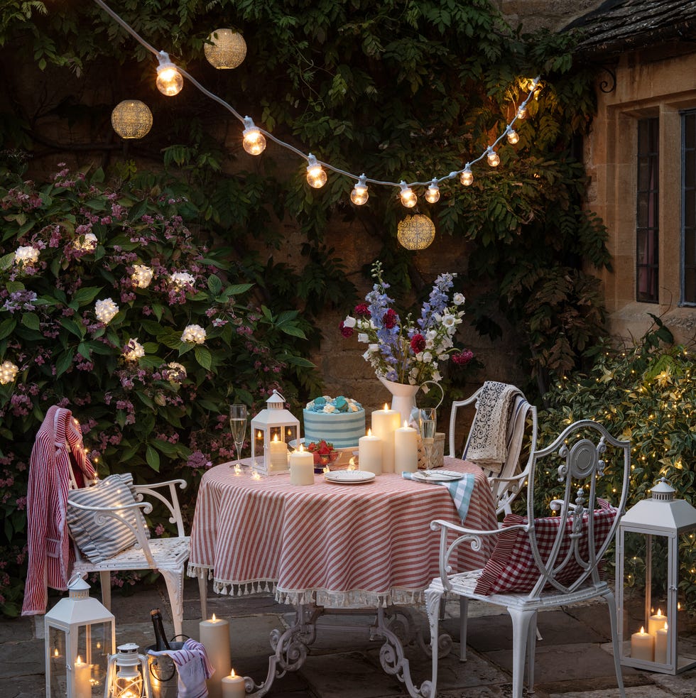 outdoor dining setup with string lights and floral decorations