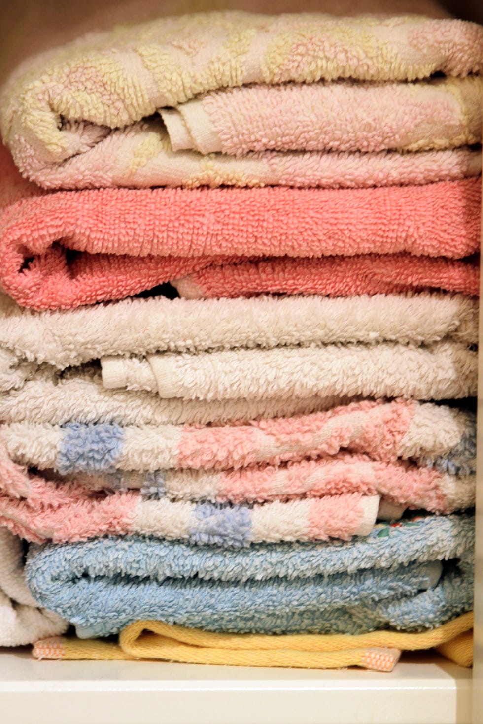 close up of stacked towels in cupboard