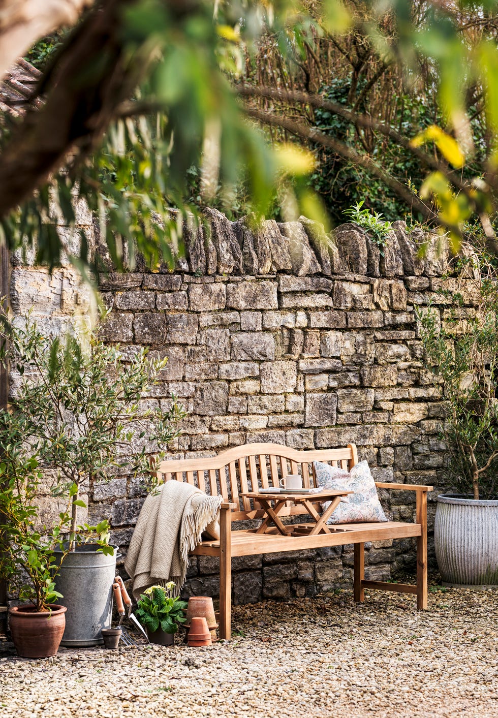 garden seating area with stone wall backdrop