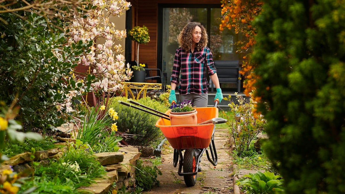 woman taking her tools down the garden