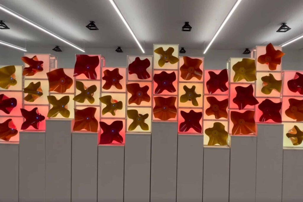 Red and yellow star-shaped light fixtures in a modern interior space.