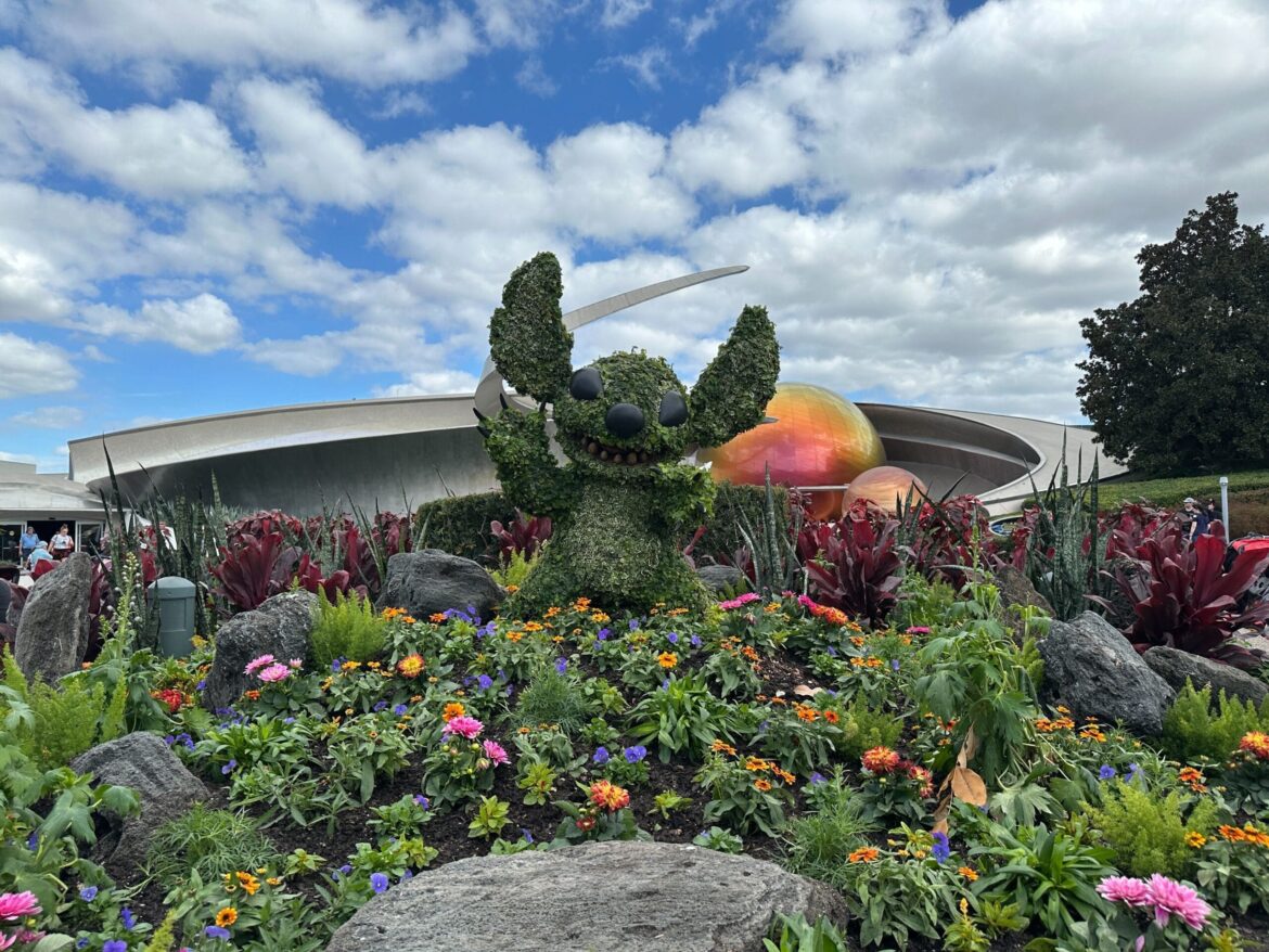 The Stitch topiary is placed inside a flower bed near Mission: SPACE.