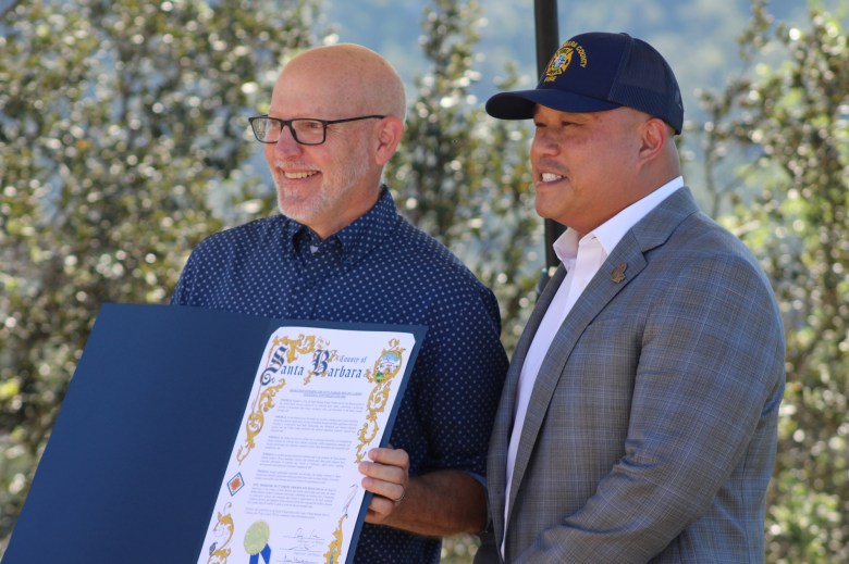 Santa Barbara Botanic Garden Executive Director Steve Windhager, left, accepts the gift of a resolution from Santa Barbara County Supervisor Roy Lee on behalf of the board.