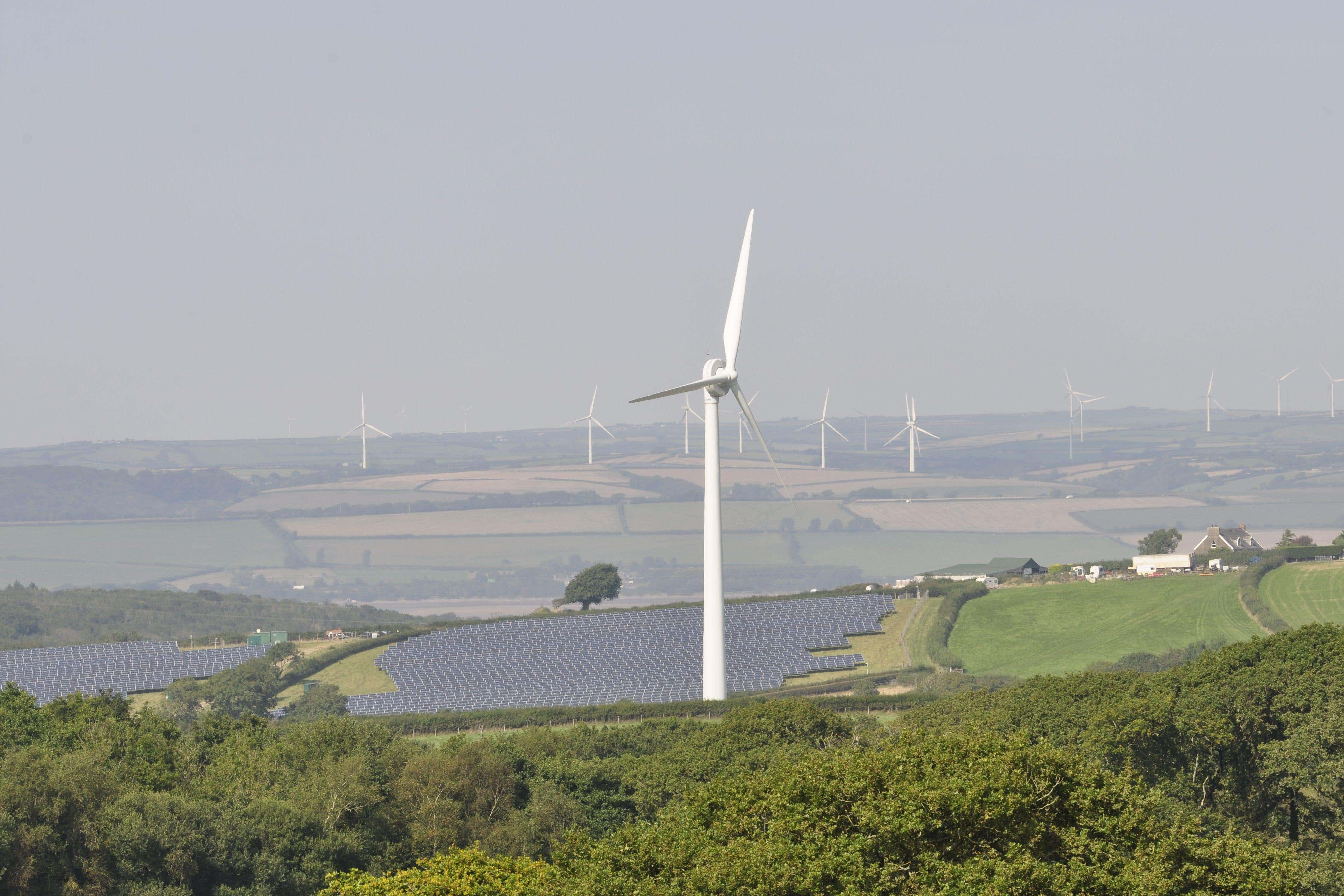 Wind turbines and solar panels on farmland in Devon