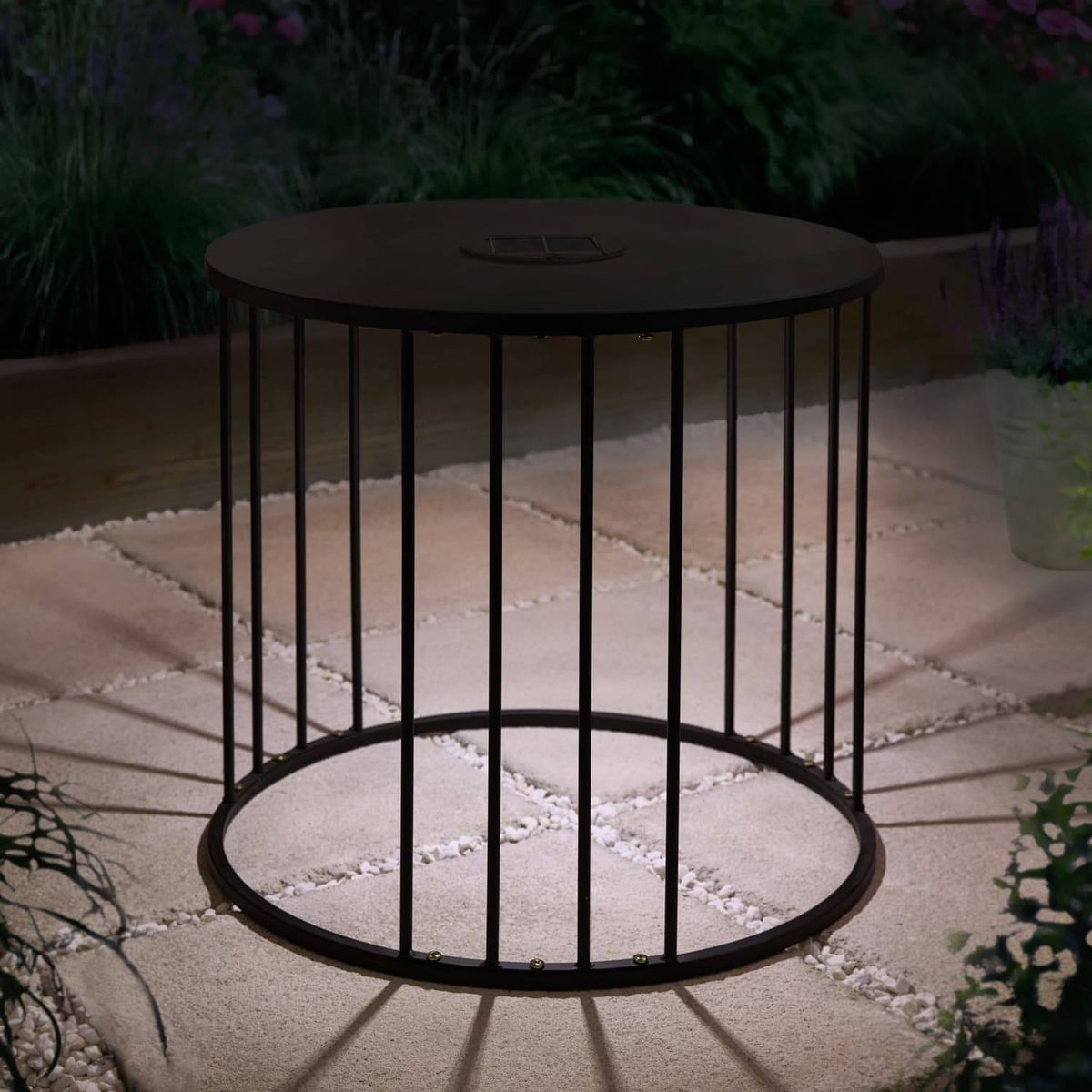 At night, it casts a warm white glow from its solar lights underneath