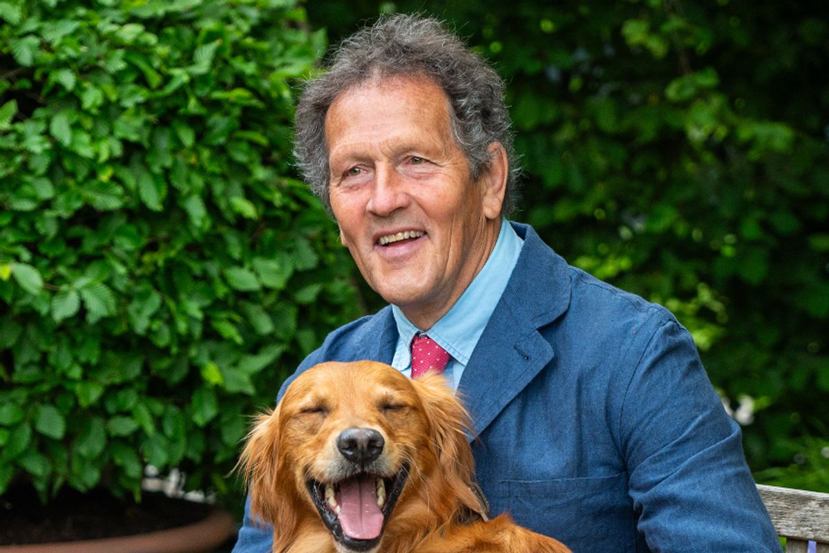 Monty Don has an informal moment with his Golden Retriever Ned on the RHS and BBC Radio 2 Dog Garden at RHS Chelsea