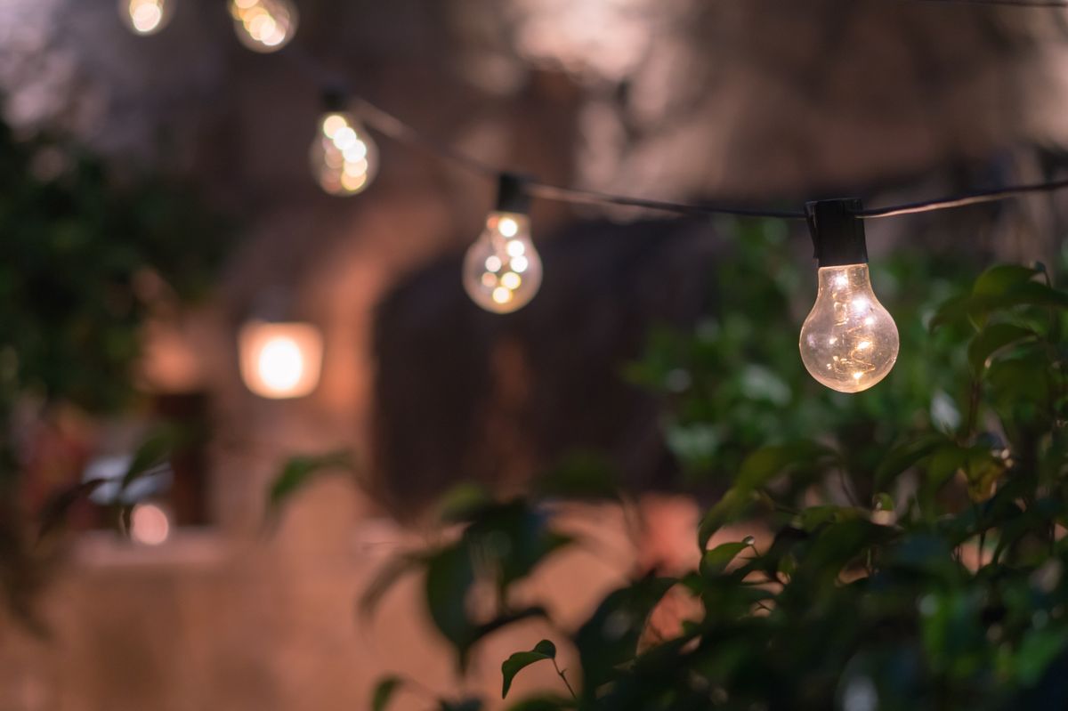 Outdoor string lights hanging on a line in backyard