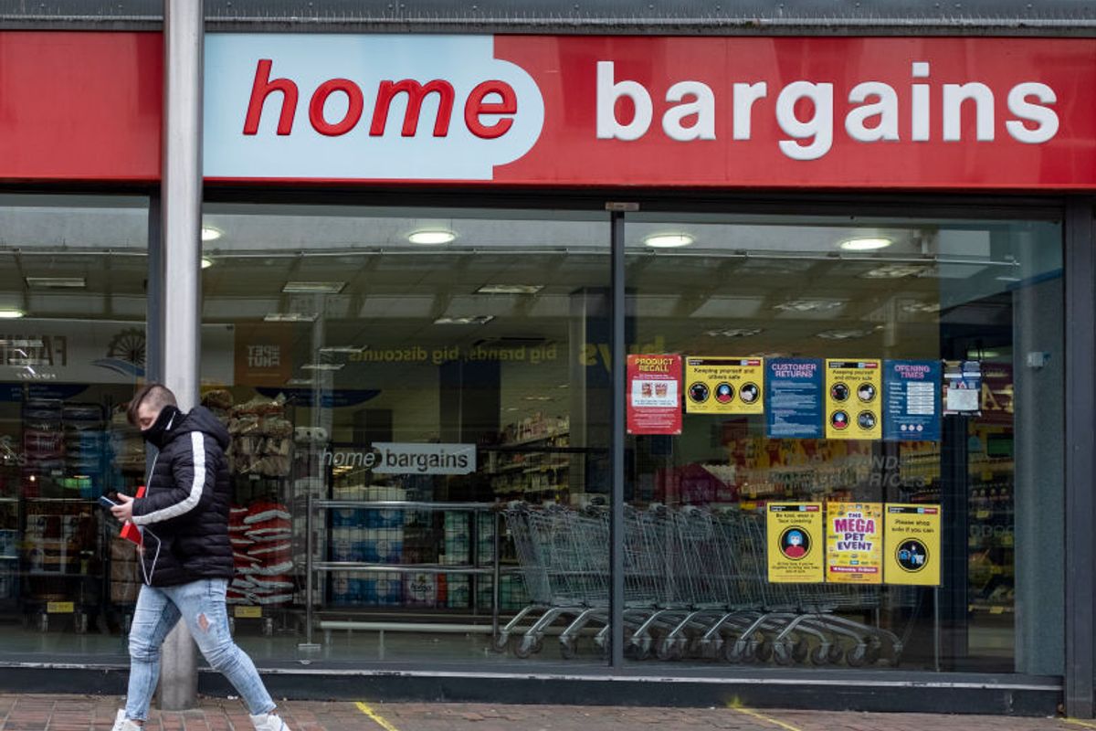 Man walking past Home Bargains shop 