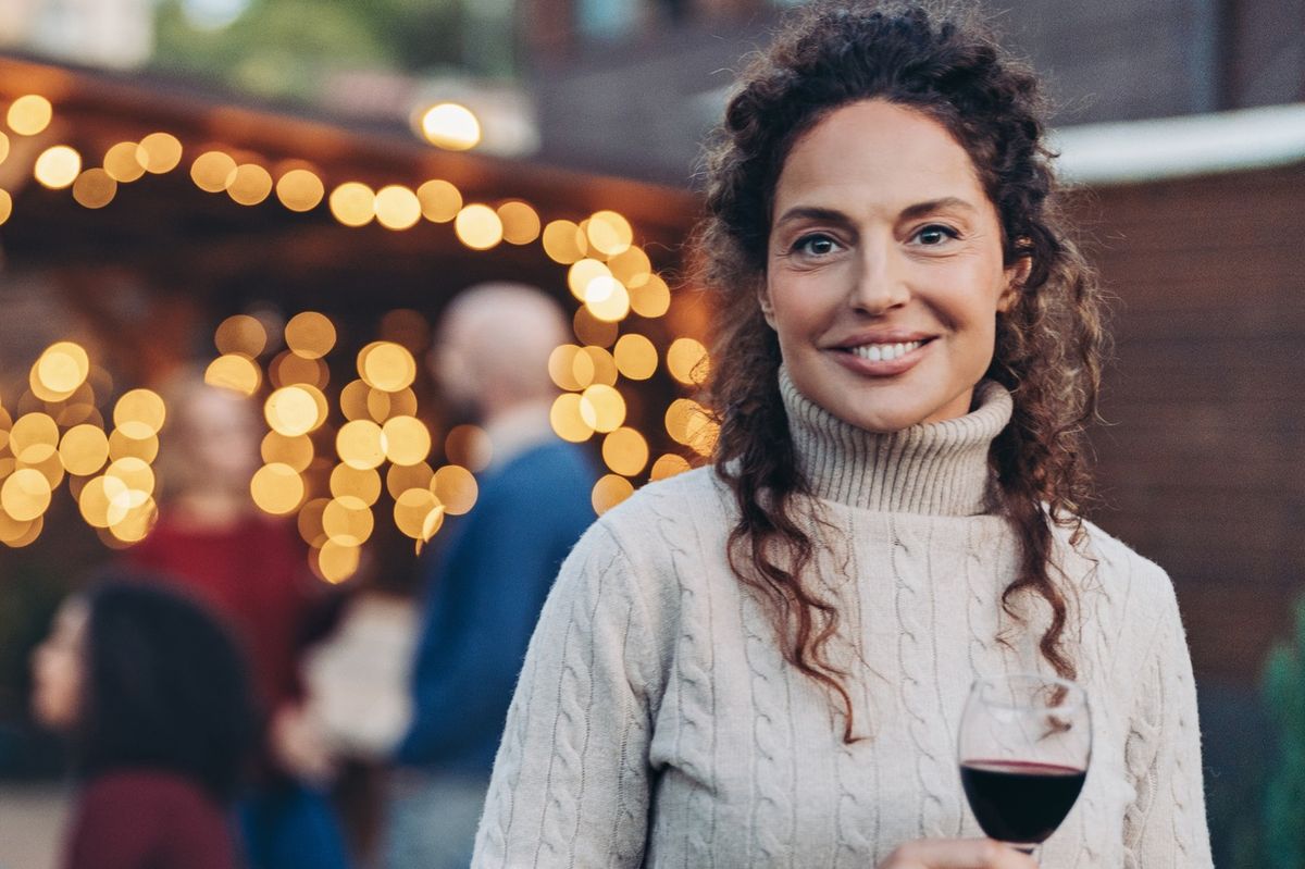 Focus on a happy middle age woman during a garden party