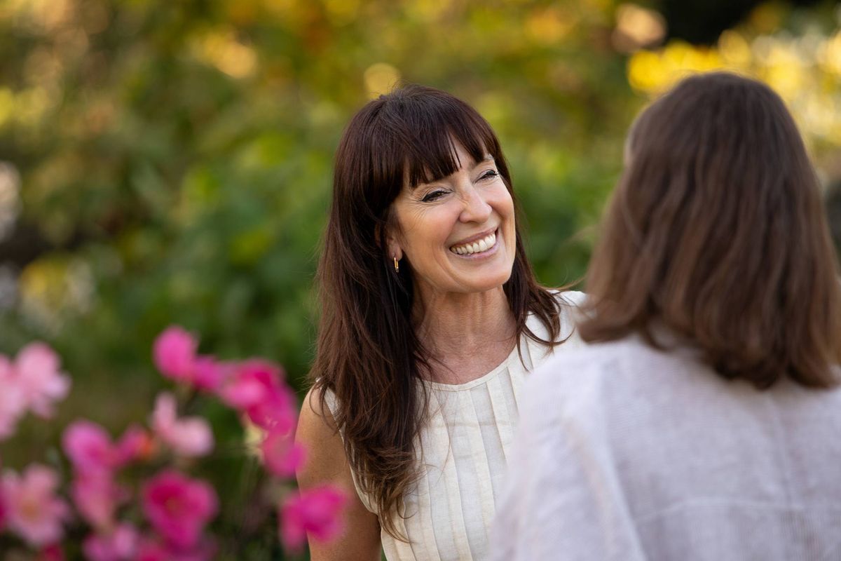 Mature Latin American women friends chatting and enjoying themselves in a blooming garden - Buenos Aires - Argentina