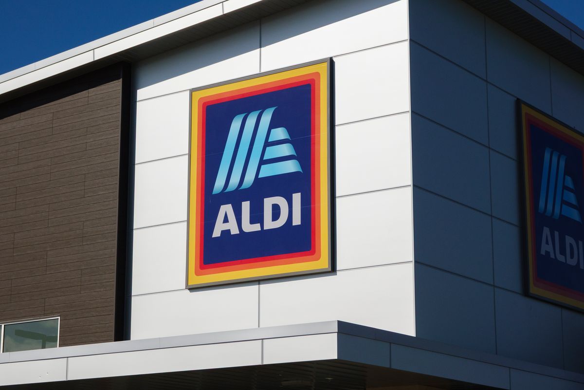 : An Aldi logo is displayed on a sign outside of a market