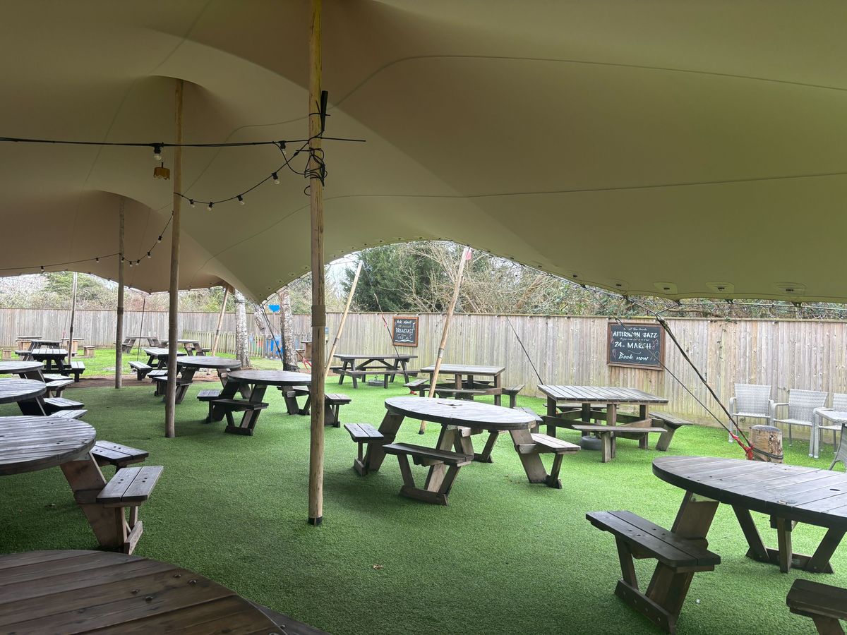 The pub has a very large canopied garden seating area with a children's playground just meters away