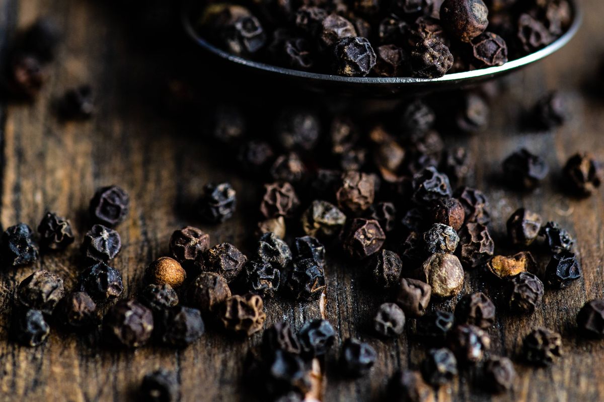 Spoonful of black peppercorns. 