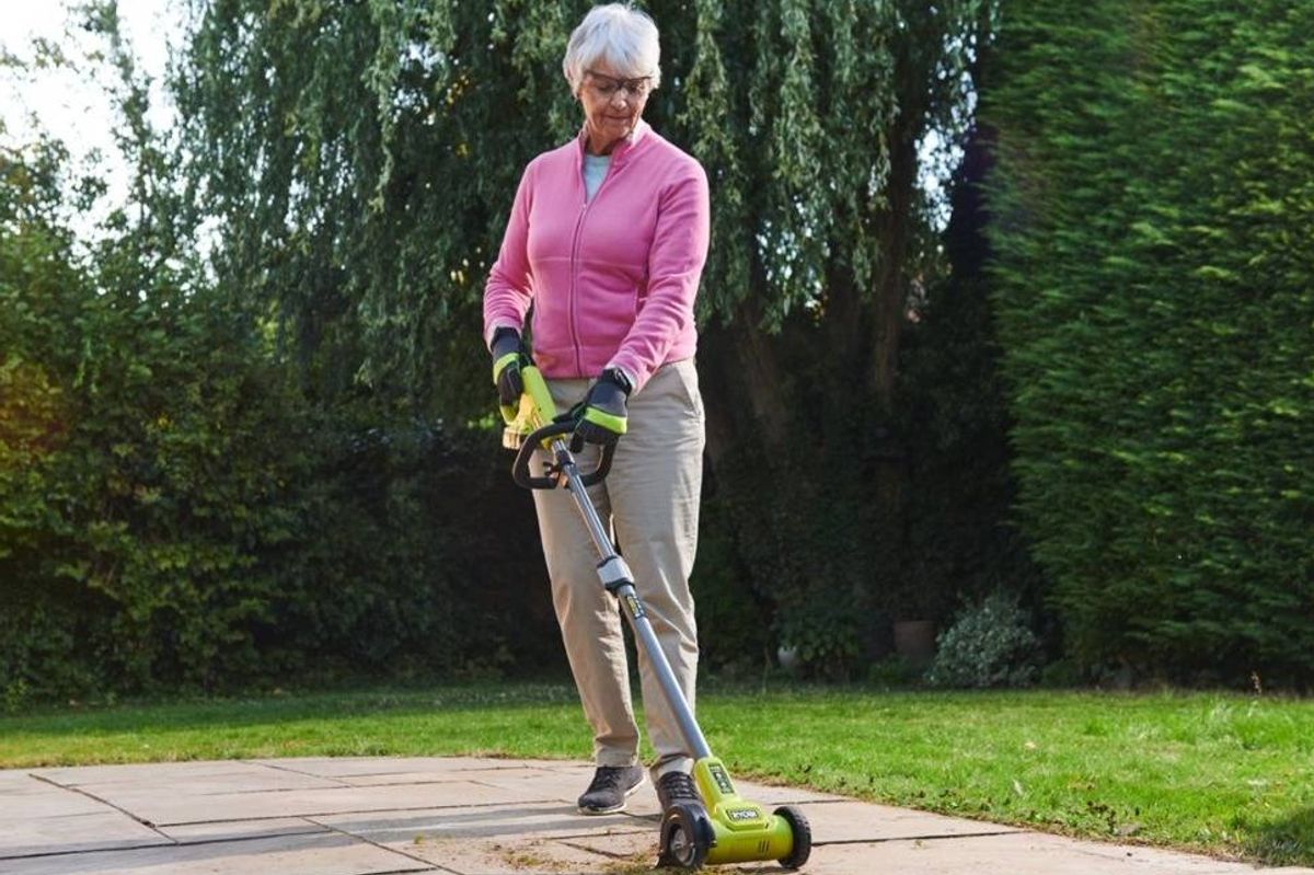 Woman using a cordless patio cleaner