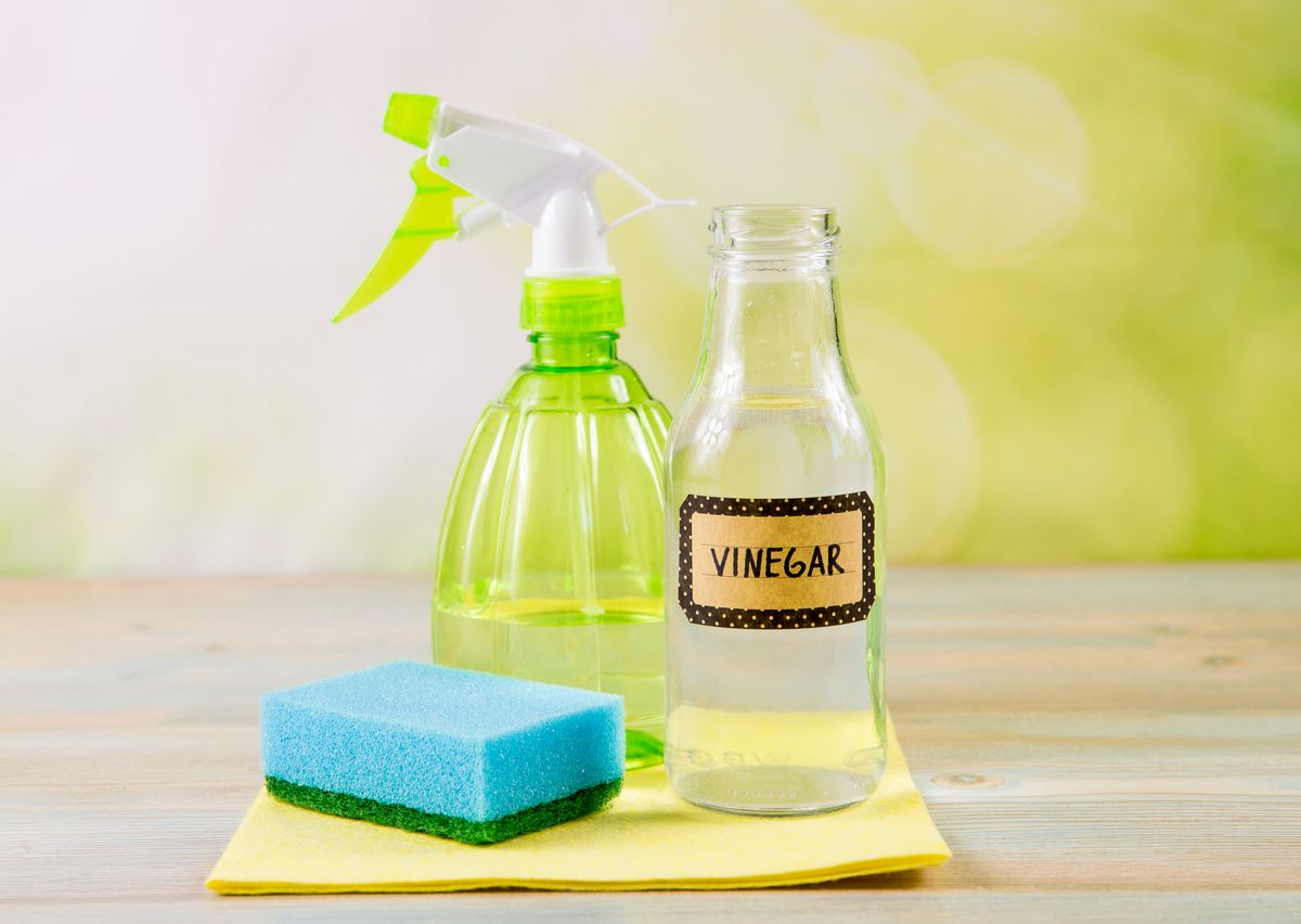 Vinegar with cleaning supplies.