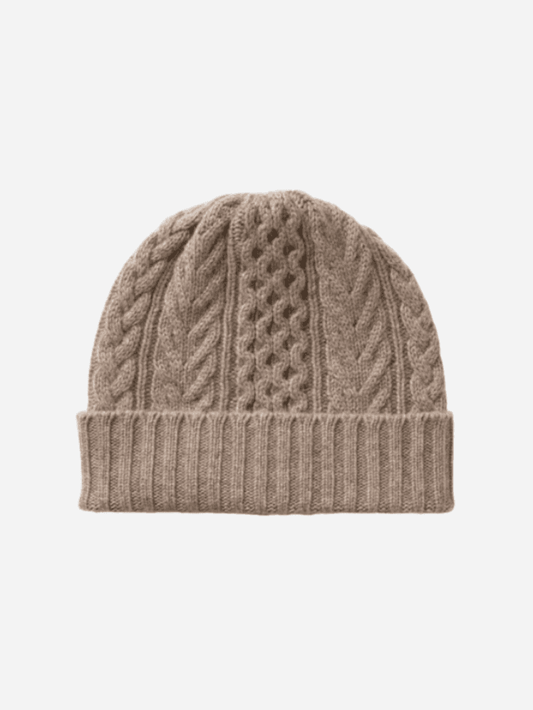 Image may contain: Clothing, Hat, Cap, Beanie, Knitwear, and Sweater