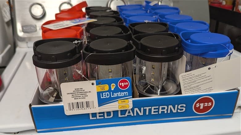 LED lanterns with black, blue, or red plastic components and price tags attached.