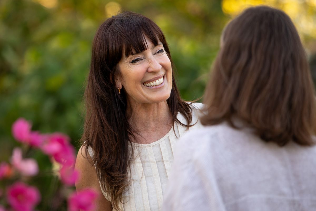 Mature Latin American women friends chatting and enjoying themselves in a blooming garden - Buenos Aires - Argentina