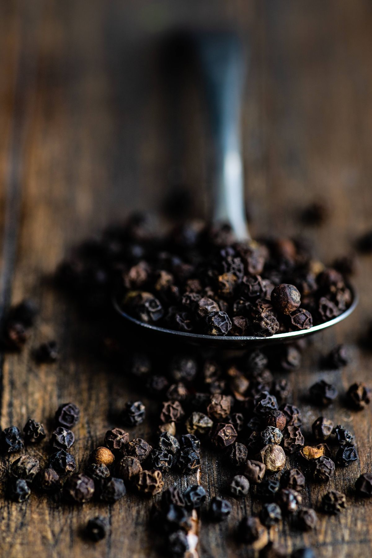 Spoonful of black peppercorns. 