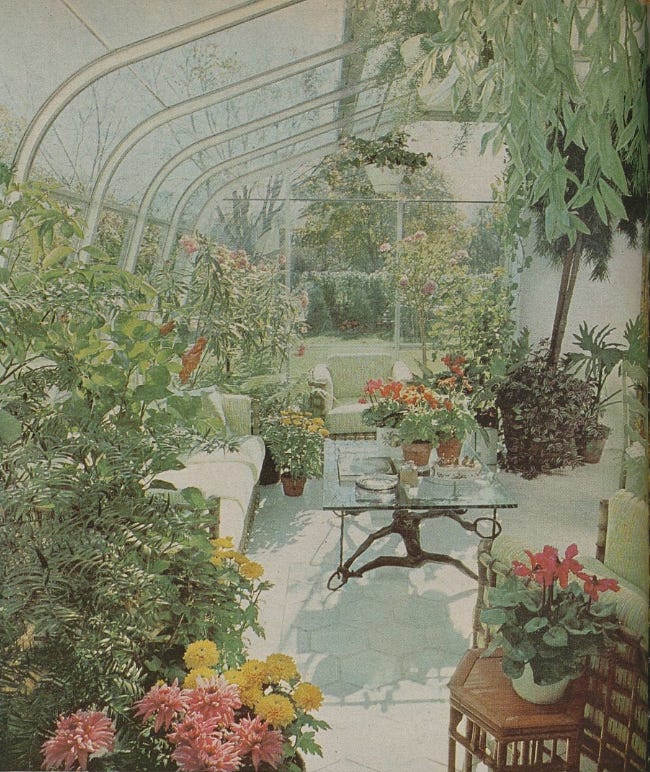 a glassenclosed garden space filled with various plants and seating