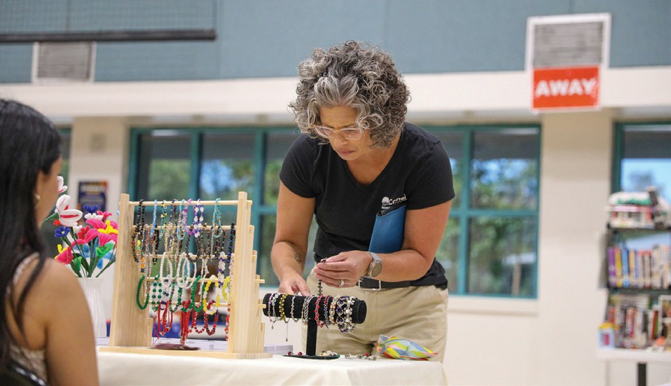 UPCOMING—T.O. teens will host the annual Teen Center Flea Market April 26. Here, shopper Julie Martin browses a selection of beaded bracelets arranged by a teen vendor at last year’s event. ALAN KO/Acorn Newspapers