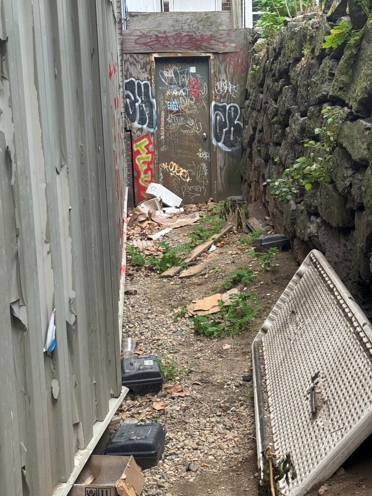 The old stone wall off Winthrop Street in Harvard Square