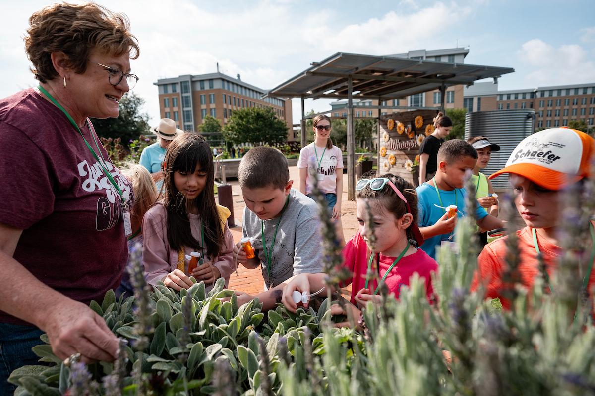 Lisa Whittlesey with a group of children touring The Gardens at Texas A&M University. 