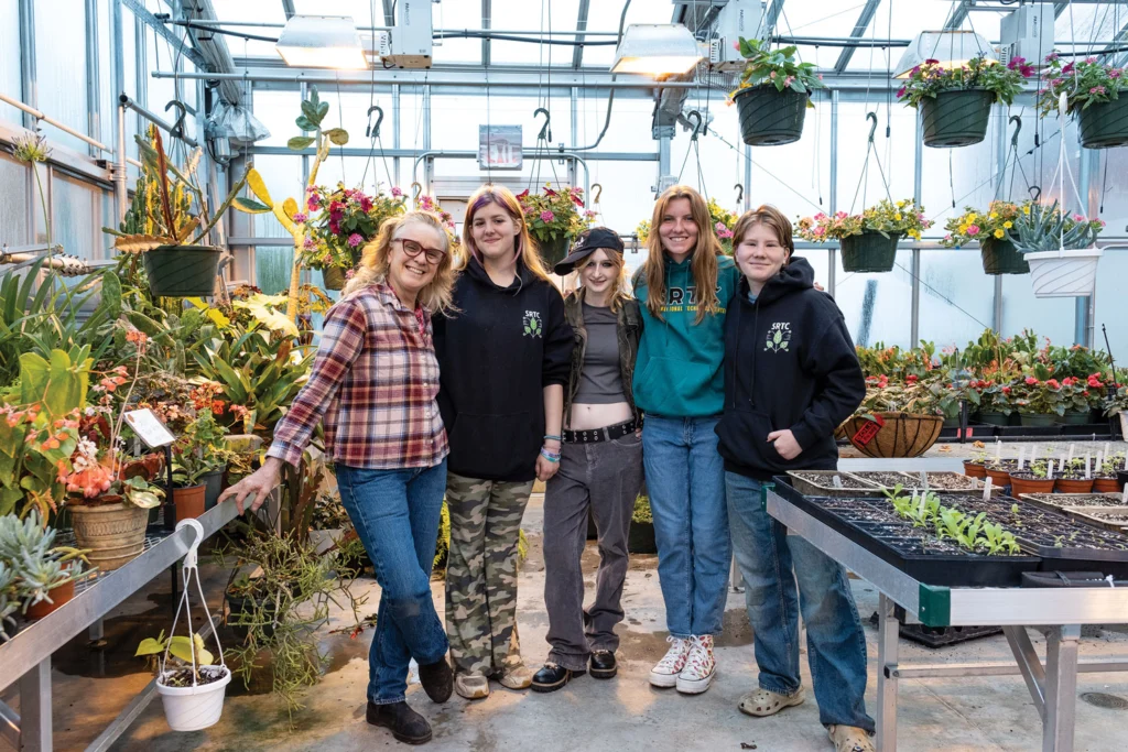 Former agriculture teacher Pamela Durack with students in the high-tech greenhouse at Sanford Regional Technical Center.