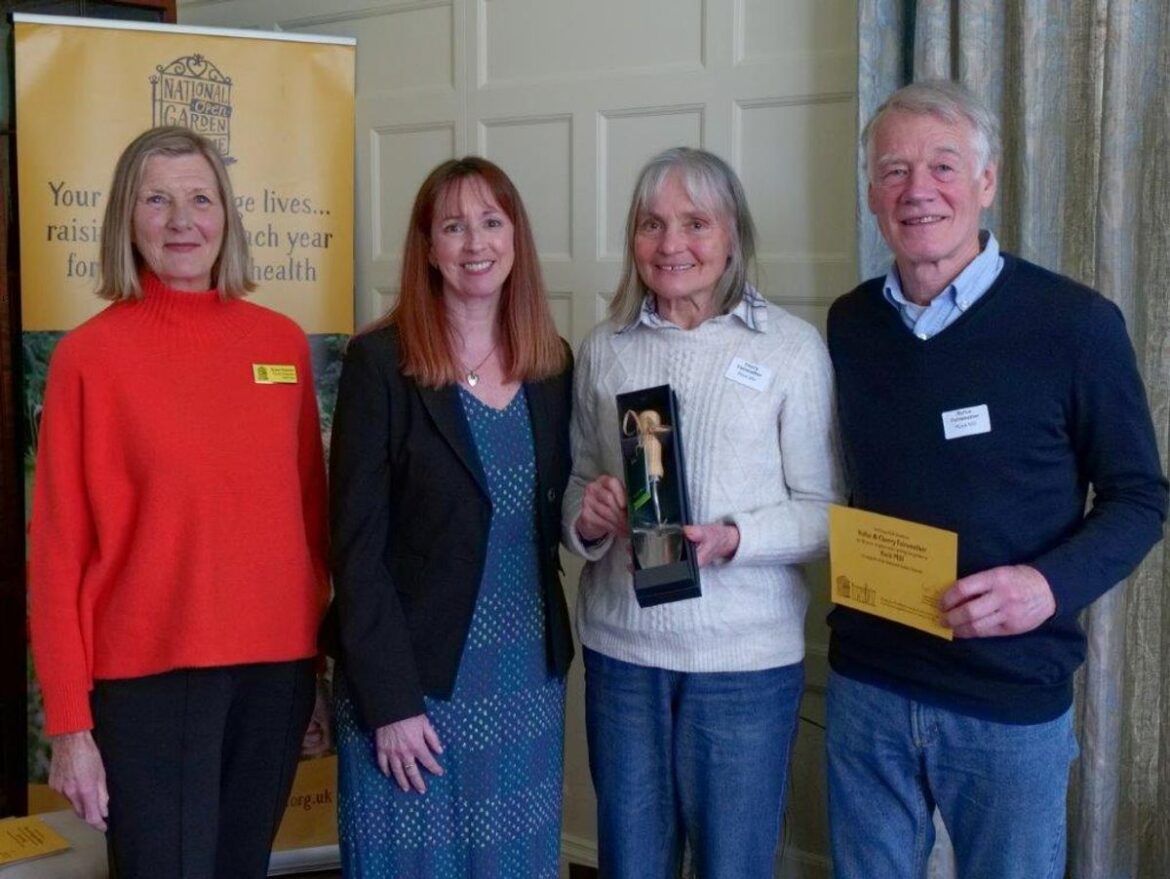 The owners of two Powys gardens have received awards after supporting the National Garden Scheme for a decade Simon Cain and Simon Quinn, Hurdley Hall, near Churchstoke receiving their awards from Nerys and Susan. Image Laura Shepherd of www.laurashepherdslensphotography.com