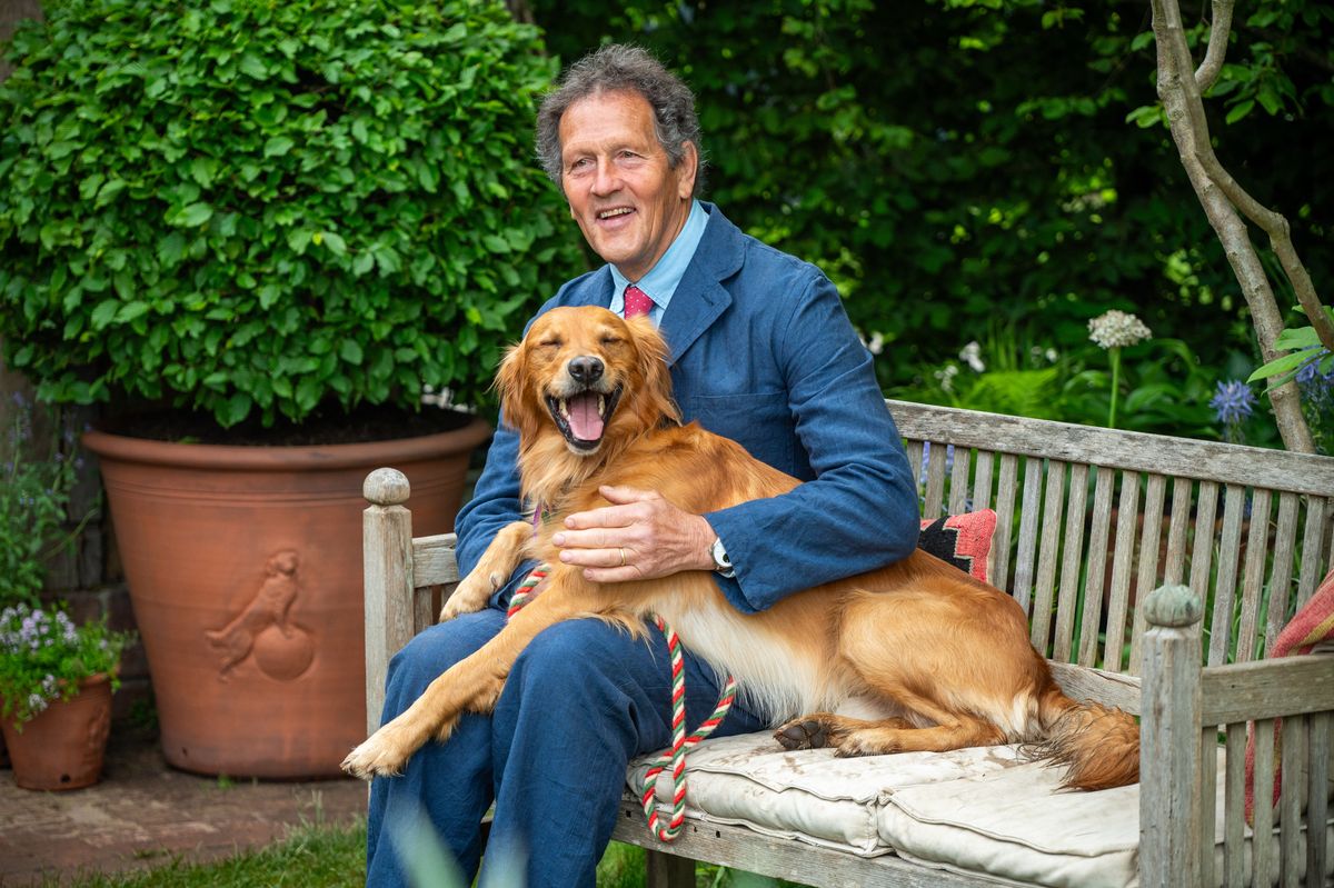 LONDON, ENGLAND - MAY 19: Monty Don has an informal moment with his Golden Retriever Ned on the RHS and BBC Radio 2 Dog Garden at RHS Chelsea on May 19, 2025 in London, England. Running from May 20-24, the annual event by the Royal Horticultural Society sees garden designers competing to earn coveted bronze, silver or gold medals with their imaginative landscapes and floral displays. (Photo by Ben Montgomery/Getty Images)