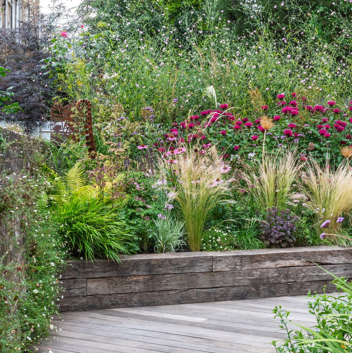 a wooden walkway in a garden