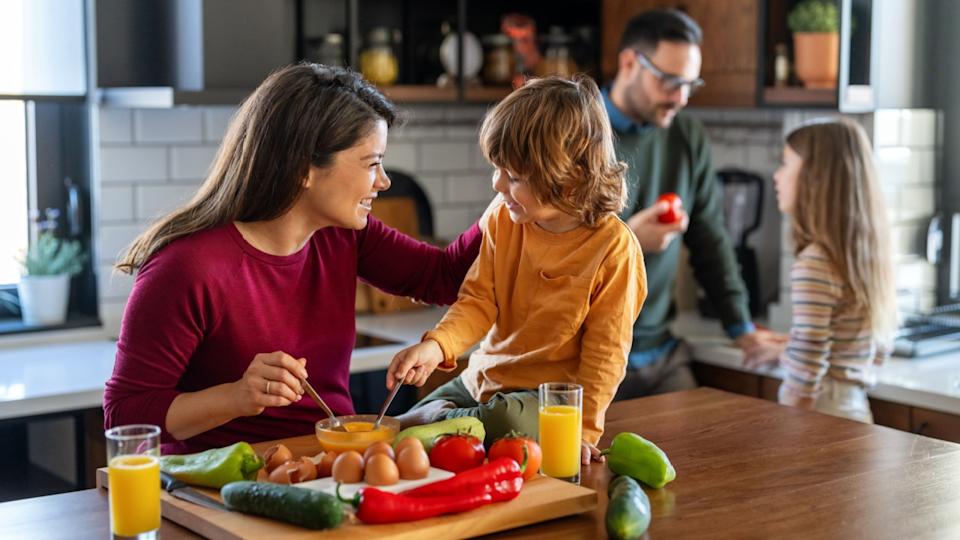 Happy family is cooking together in a bright kitchen, showing joy, teamwork, and love at home