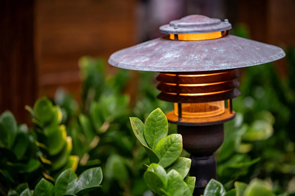 outdoor lamp among green foliage
