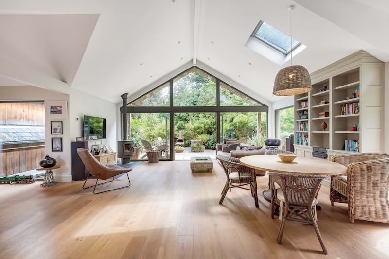 Living and dining area has skylights overhead, installed within the Brazilian natural slate roof