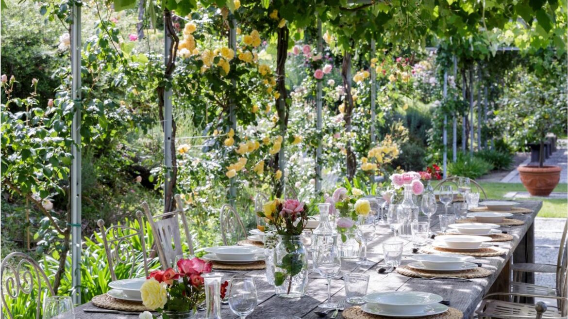 Secrets to Smarter Hosting in 2026: 3 Easy Upgrades Alfresco garden dining table underneath vines. Table decorated with florals
