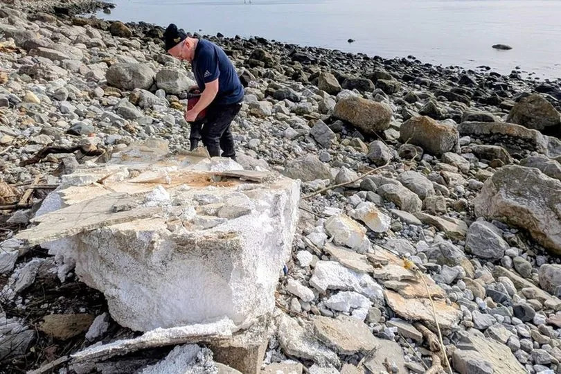 A volunteer vacuums more debris