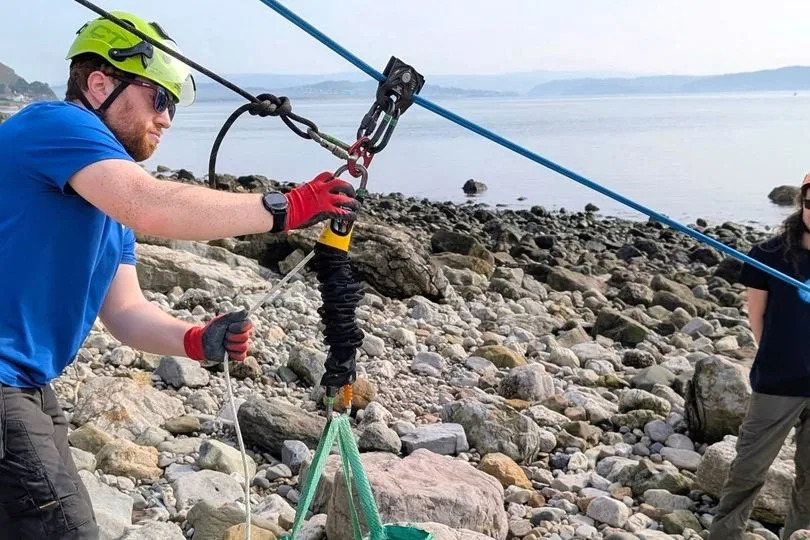 Once broken up, smaller polystyrene pieces were lifted up cliffs using a zip line