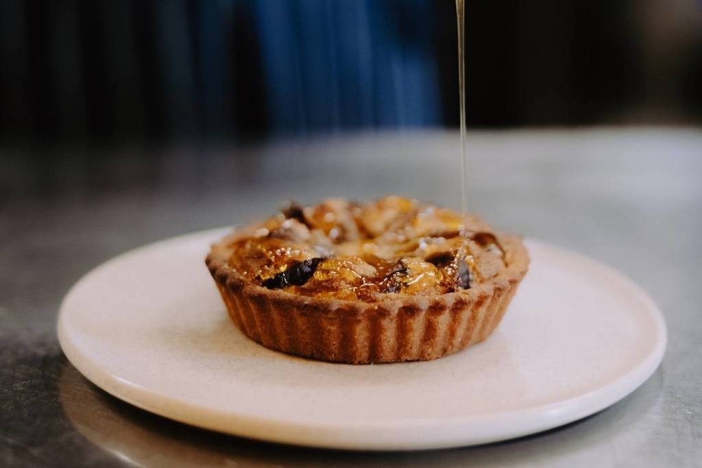 tart being drizzled with honey