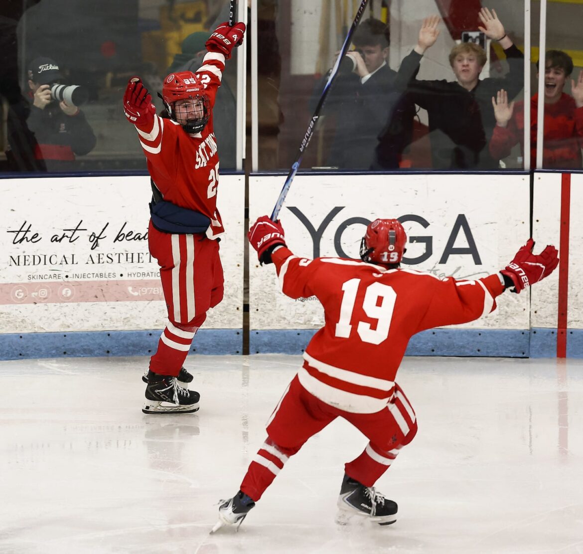 St. John's senior defenseman Kevin Bisson (left) celebrated his double-overtime winner against Arlington with teammate Jaydon Wrzosek at Chelmsford Forum.