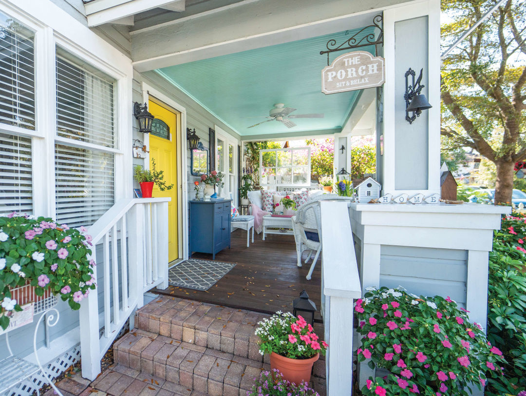 A storybook porch adorned with flowers.