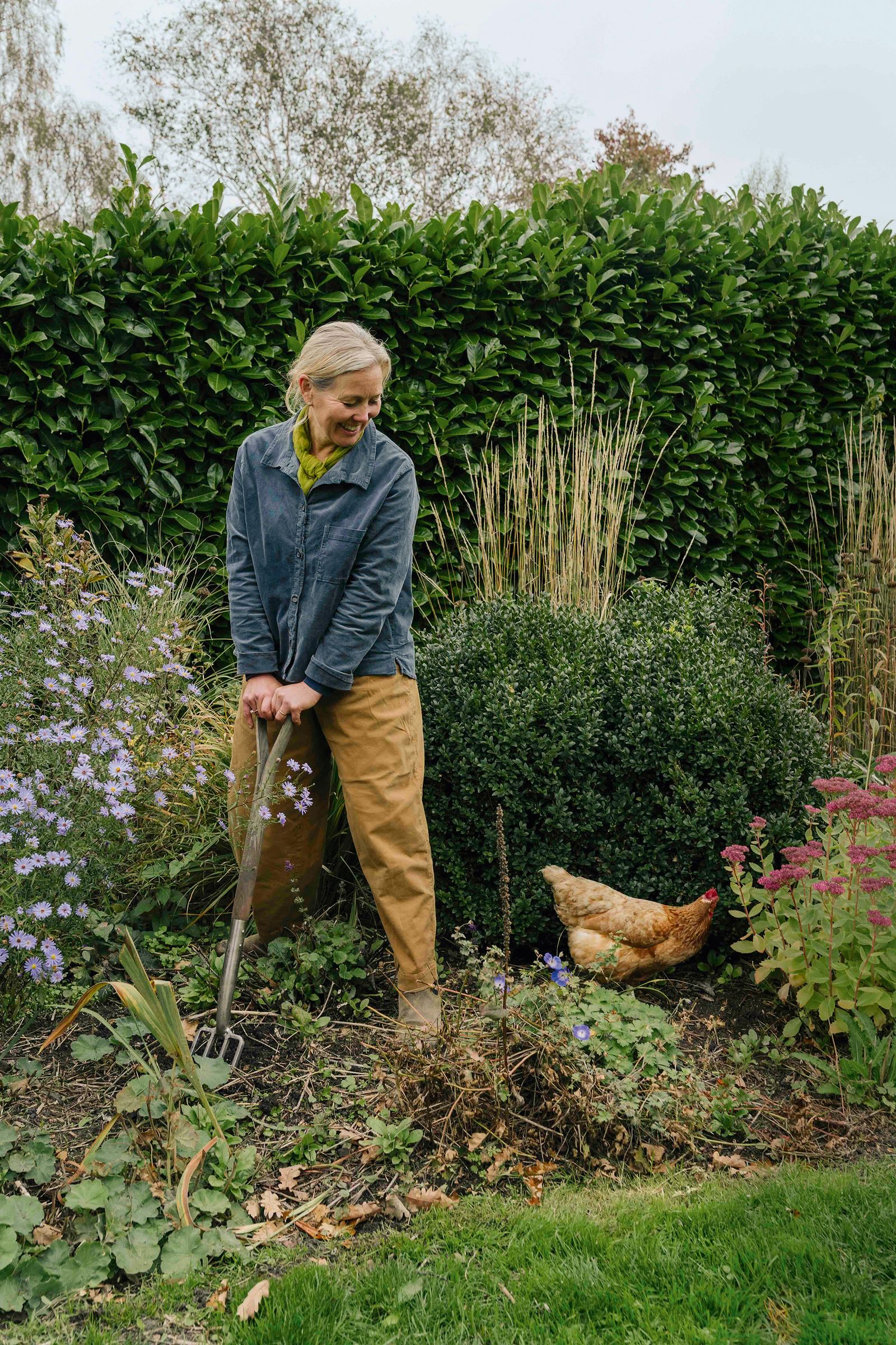 Image may contain Garden Nature Outdoors Gardening Gardener Person Animal Bird Chicken Fowl Poultry and Adult