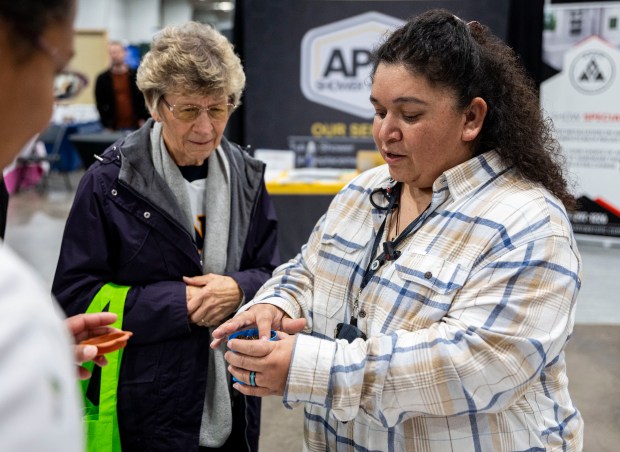 Eugenia Ramirez, right, from Greeley Evans School District 6 Transportation, prepares cherry tomato seeds to give away to Esther Daugherty, left, during the Greeley Tribune's Home & Garden Show at the Island Grove Event Center in Greeley on Friday, March 6, 2026. (Brice Tucker/Staff Photographer)
