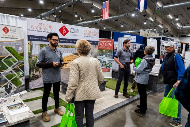 System Pavers salesmen talk to people at their booth during the Greeley Tribune's Home & Garden Show at the Island Grove Event Center in Greeley on Friday, March 6, 2026. (Brice Tucker/Staff Photographer)