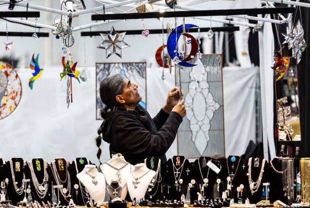 Ricardo Martinez hangs up his products during the Greeley Tribune's Home & Garden Show at the Island Grove Event Center in Greeley on Friday, March 6, 2026. (Brice Tucker/Staff Photographer).