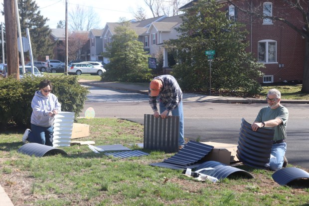 Keystone Opportunity Center staff members begin work on installing the Community Garden's first several raised beds. (John Worthington - MediaNews Group)